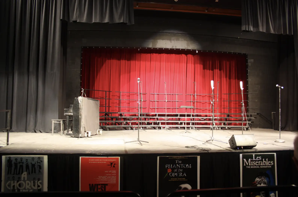 Students and parent volunteers worked hard to set up the stage for the choir performers.